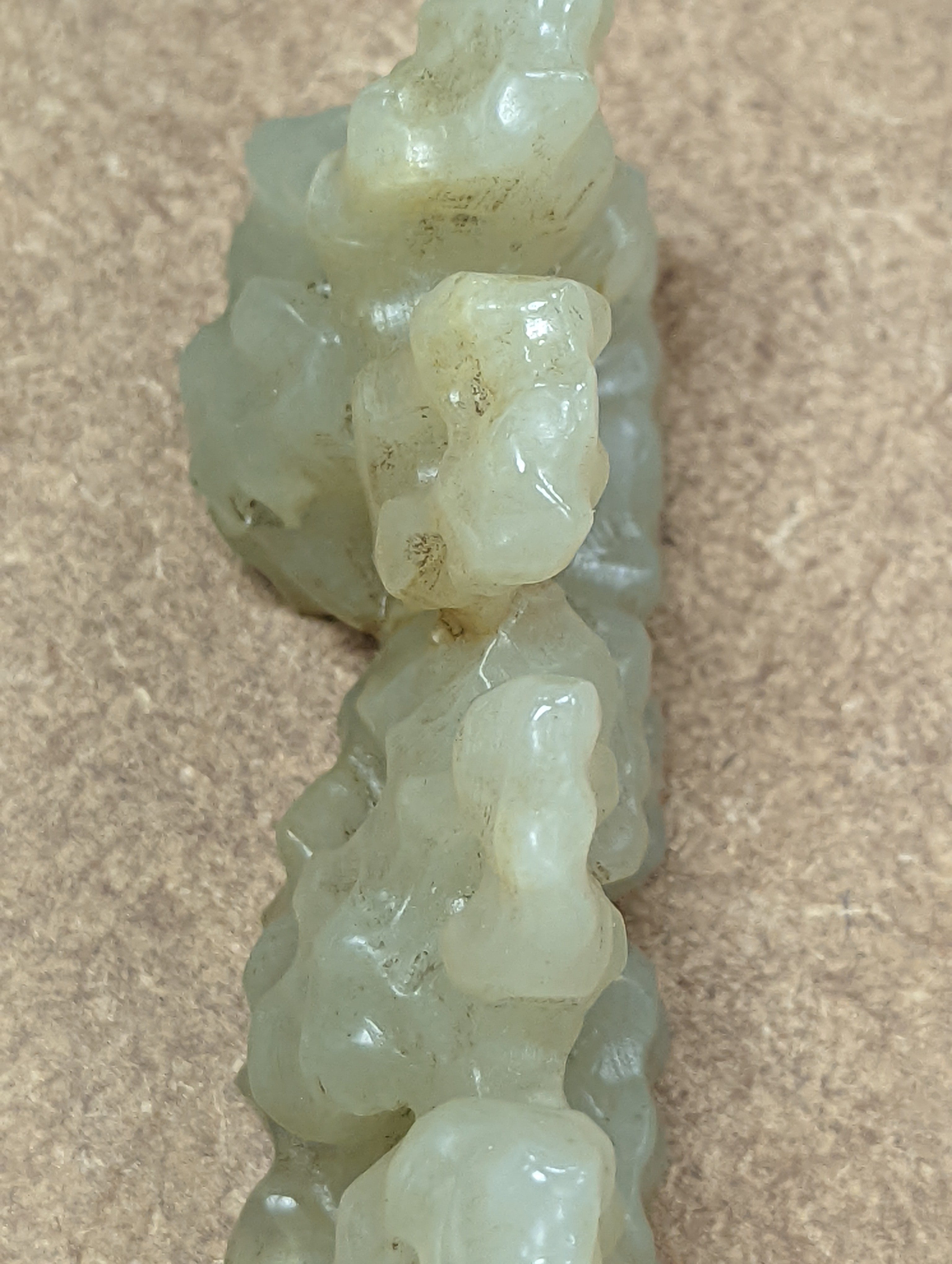 A Chinese celadon jade brush rest, 8cms wide